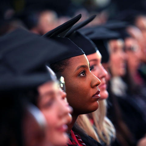 A graduating student looks intently into the future