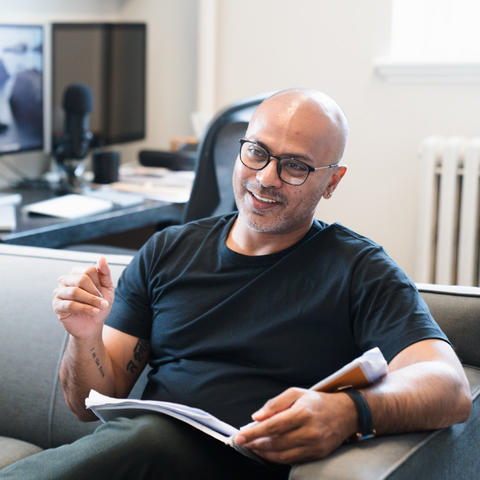A man sits in a multimedia office and shares his expertise