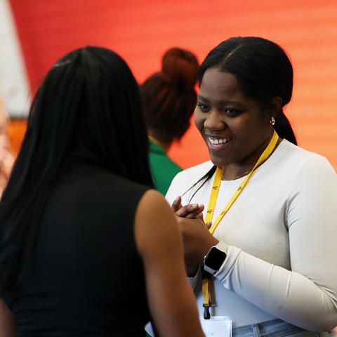 A Student has a conversation at a networking event
